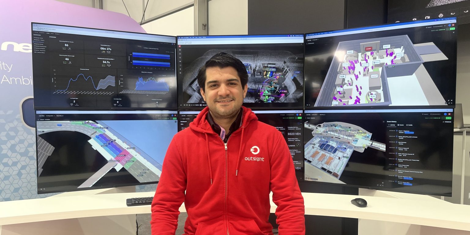 Eduardo de la Espriella at the Outsight booth at Mobile World Congress 2026, in front of six dashboards showing SHIFT in use